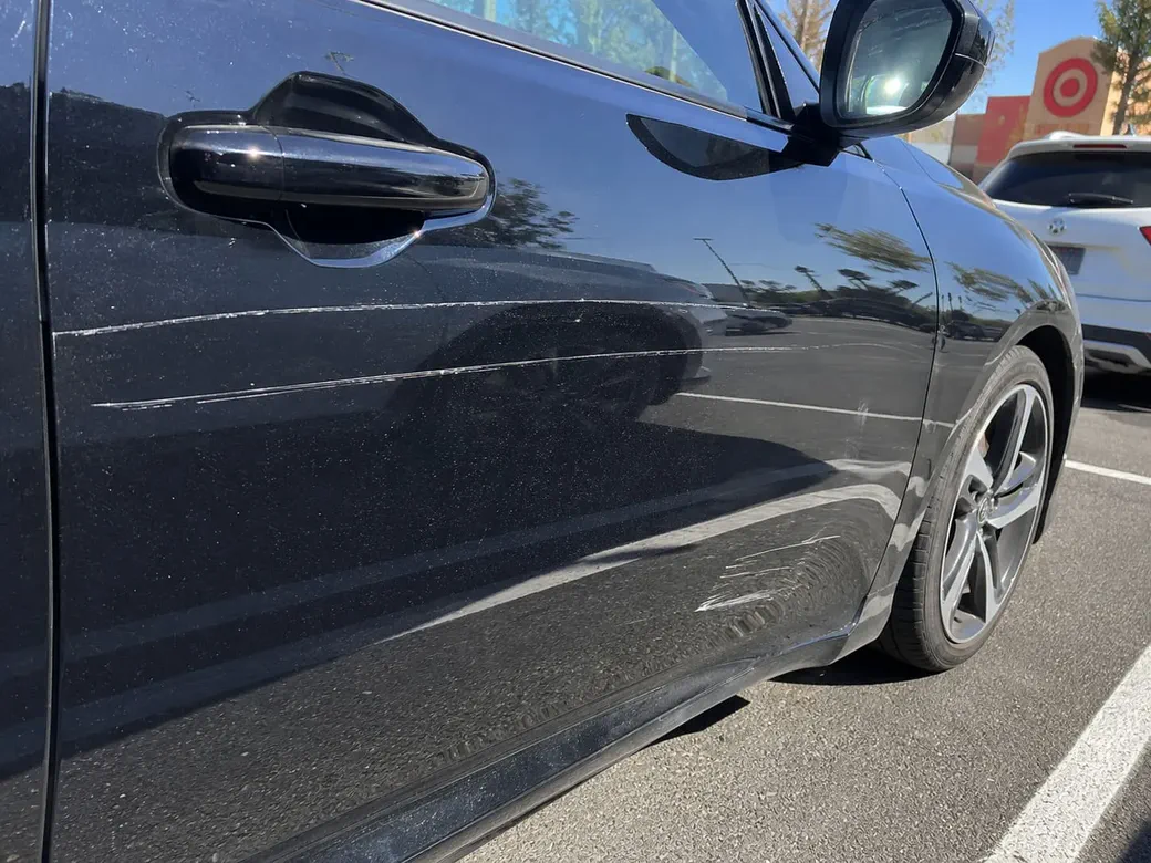 Scratched car bumper and door
