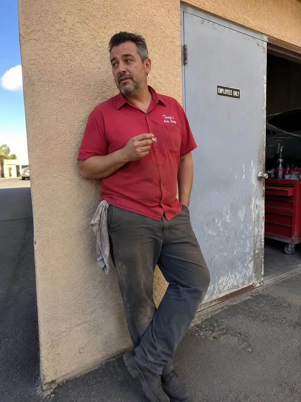 Auto body technician outside shop